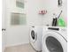 Bright laundry room with washer, dryer, and storage at 1829 Tropical Palms Cir Cir, Kissimmee, FL 34747