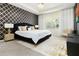 Spacious main bedroom with a black velvet headboard, gold accents, and large windows at 1829 Tropical Palms Cir Cir, Kissimmee, FL 34747