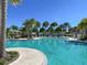 Resort-style pool with palm trees and lounge chairs at 1829 Tropical Palms Cir Cir, Kissimmee, FL 34747