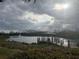 Scenic lakefront gazebo with a wooden deck at 185 Mitchells Mnr, Haines City, FL 33844