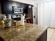 Kitchen features granite countertops and dark cabinetry at 1855 Caralee Blvd # 2, Orlando, FL 32822