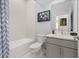 Clean bathroom with a tub, toilet and modern vanity at 1867 Flora Pass Pl, Kissimmee, FL 34747