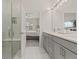 Modern bathroom with double vanity, walk-in shower, and bedroom view at 1867 Flora Pass Pl, Kissimmee, FL 34747