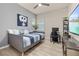 Cozy bedroom featuring a daybed, workspace, and large TV at 1867 Flora Pass Pl, Kissimmee, FL 34747