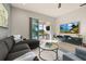 Gathering room with sectional sofa, coffee table, and large TV at 1867 Flora Pass Pl, Kissimmee, FL 34747