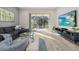 Gathering room with sectional sofa, coffee table, and large TV at 1867 Flora Pass Pl, Kissimmee, FL 34747