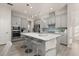 Modern kitchen with gray cabinets, island, and stainless steel appliances at 1867 Flora Pass Pl, Kissimmee, FL 34747