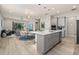 Modern kitchen with gray cabinets, island, and stainless steel appliances at 1867 Flora Pass Pl, Kissimmee, FL 34747