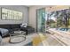 Living room with sectional sofa and access to screened lanai and pool at 1867 Flora Pass Pl, Kissimmee, FL 34747