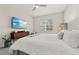 Main bedroom with king-size bed and large TV at 1867 Flora Pass Pl, Kissimmee, FL 34747