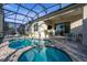 Spacious pool and spa area with screened enclosure and patio furniture at 1867 Flora Pass Pl, Kissimmee, FL 34747