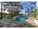 Relaxing screened pool and spa with patio and golf course view at 1867 Flora Pass Pl, Kissimmee, FL 34747
