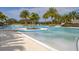 Large resort-style pool with palm trees and lounge chairs at 1867 Flora Pass Pl, Kissimmee, FL 34747