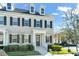 Two-story townhome with gray siding, dark shutters, and a front porch at 1867 Island Village Way, Celebration, FL 34747