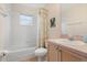 Bathroom with tub, toilet, and updated vanity at 201 Steamboat Blvd, Davenport, FL 33897