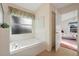 Bathroom with a large tub and adjacent bedroom view at 201 Steamboat Blvd, Davenport, FL 33897