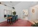 Bright dining room with wood table and teal chairs, offering view into kitchen at 201 Steamboat Blvd, Davenport, FL 33897