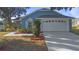 Single-story home with light blue exterior and attached garage at 201 Steamboat Blvd, Davenport, FL 33897