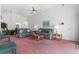 Living room with couches, coffee table, and pink carpeting at 201 Steamboat Blvd, Davenport, FL 33897