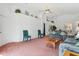 Spacious living room with pink carpet and a view of the dining area at 201 Steamboat Blvd, Davenport, FL 33897