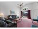 Living room with couches, coffee table, and pink carpeting at 201 Steamboat Blvd, Davenport, FL 33897