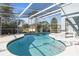 Relaxing kidney-shaped pool with screened enclosure, offering privacy and sun at 201 Steamboat Blvd, Davenport, FL 33897