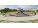 Community playground with playset and benches at 219 Bull Frog Ln, Umatilla, FL 32784