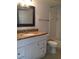 Bathroom features granite countertop and white cabinets at 2218 Grand Cayman Ct # 1335, Kissimmee, FL 34741