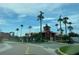 Community entrance with palm trees and building at 2218 Grand Cayman Ct # 1335, Kissimmee, FL 34741