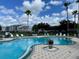 Community pool with lounge chairs and a surrounding patio at 2218 Grand Cayman Ct # 1335, Kissimmee, FL 34741