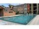 Refreshing community pool with lounge chairs and building views at 2218 Grand Cayman Ct # 1335, Kissimmee, FL 34741