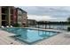 Refreshing community swimming pool with lounge chairs at 2218 Grand Cayman Ct # 1335, Kissimmee, FL 34741