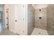 Elegant walk-in shower featuring tiled walls and a modern fixture with door to hall at 2849 Sw 137Th Ln, Ocala, FL 34473