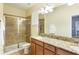 Bathroom with double vanity, granite countertop and shower at 2950 Buccaneer Palm Rd, Kissimmee, FL 34747