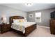 Main bedroom with king-size bed and wooden furniture at 2950 Buccaneer Palm Rd, Kissimmee, FL 34747