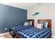 Bedroom with two twin beds and blue accents at 2950 Buccaneer Palm Rd, Kissimmee, FL 34747