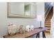 Entryway with console table, mirror, and stairs at 2950 Buccaneer Palm Rd, Kissimmee, FL 34747