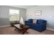 Cozy sitting area with blue sofa and wooden coffee table at 2950 Buccaneer Palm Rd, Kissimmee, FL 34747