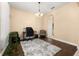 Bright dining room features hardwood floors, a chandelier, and an adjacent work area at 3061 Palermo Rose Way, Kissimmee, FL 34746