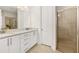 Bathroom with double vanity, shower, and white cabinets at 370 Burma St, Kissimmee, FL 34747
