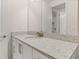 Simple bathroom with granite countertop and white cabinets at 370 Burma St, Kissimmee, FL 34747
