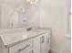 Vanity with granite countertop and a large mirror at 370 Burma St, Kissimmee, FL 34747
