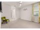 Bedroom with green chair and neutral wall decor at 370 Burma St, Kissimmee, FL 34747