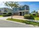 Two-story house with green exterior, brick pavers, and a two-car garage at 370 Burma St, Kissimmee, FL 34747