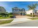Two-story house with green exterior, brick pavers, and a two-car garage at 370 Burma St, Kissimmee, FL 34747