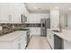 Modern kitchen with white cabinets, granite countertops, and stainless steel appliances at 370 Burma St, Kissimmee, FL 34747