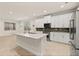 Modern kitchen with white cabinets, granite countertops, and stainless steel appliances at 370 Burma St, Kissimmee, FL 34747