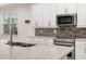 Modern kitchen with island, white cabinets, and stainless steel appliances at 370 Burma St, Kissimmee, FL 34747