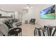 Living area showcasing curved sectional sofa and large TV at 370 Burma St, Kissimmee, FL 34747