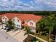 Aerial view of townhouses with private parking and lush landscaping at 4723 Terrasonesta Dr, Davenport, FL 33837